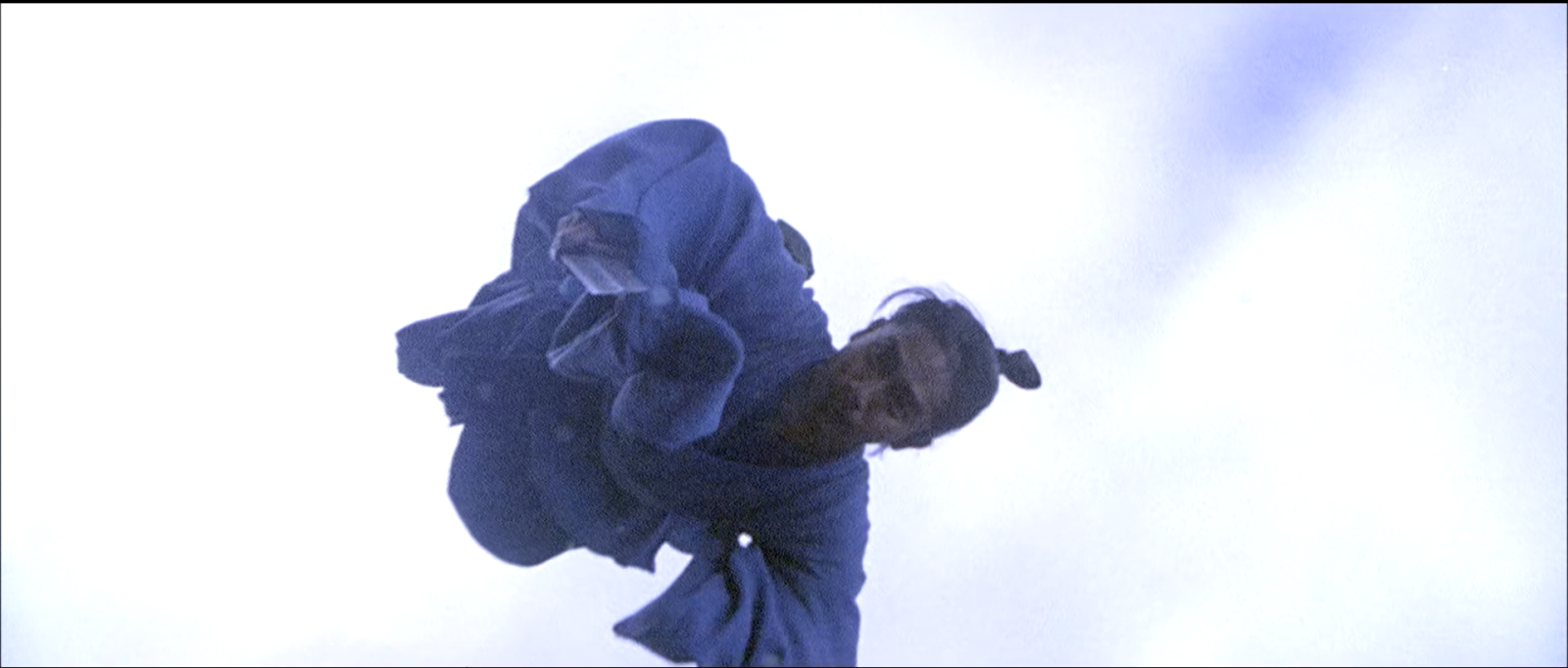 A figure in blue robes falling through a blank white sky.