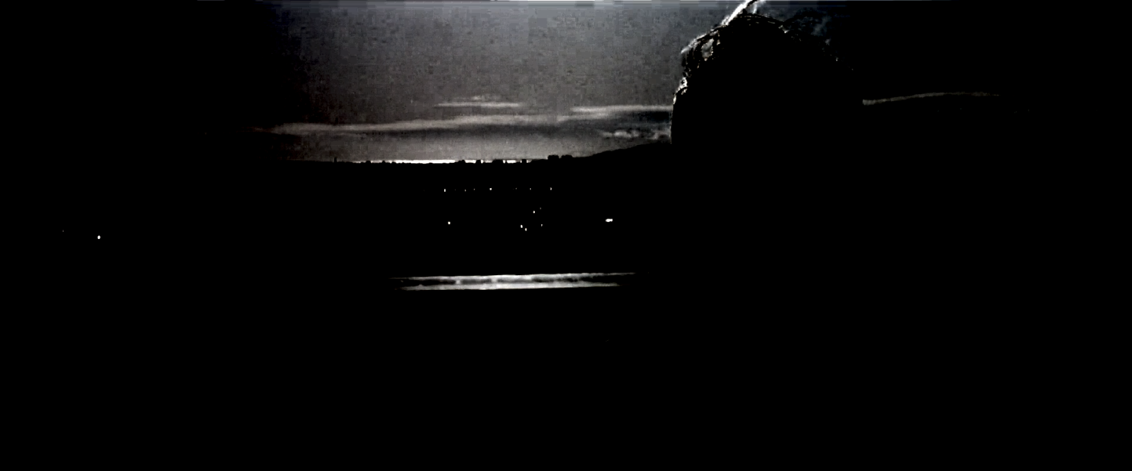 The same frame with everything below L* 85 removed, showing cloud banding, distant city lights, water glints and hair detail.