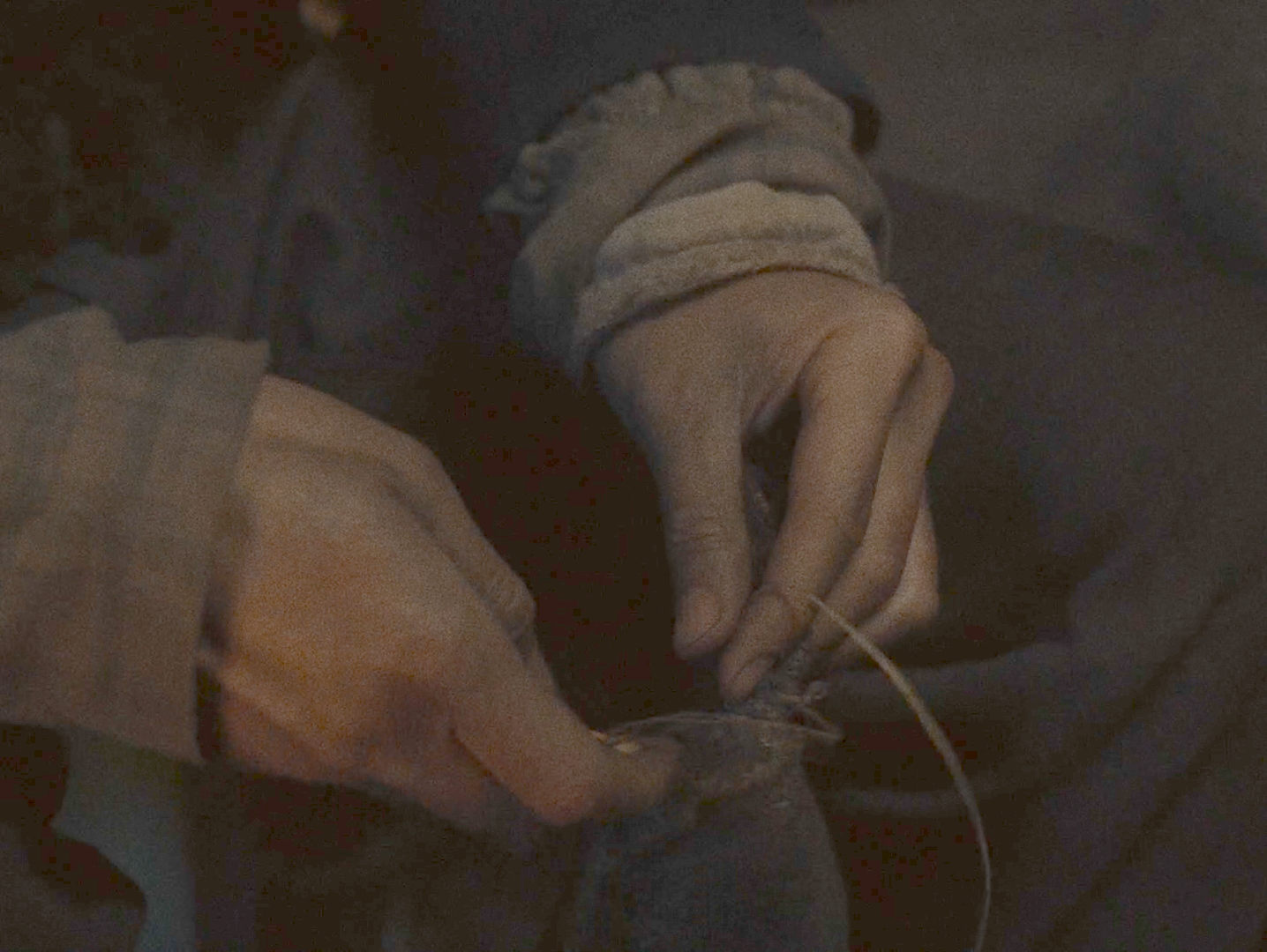 The same frame after a monotone gamma lift, showing the cloth, the background bedding and the shape of the room.