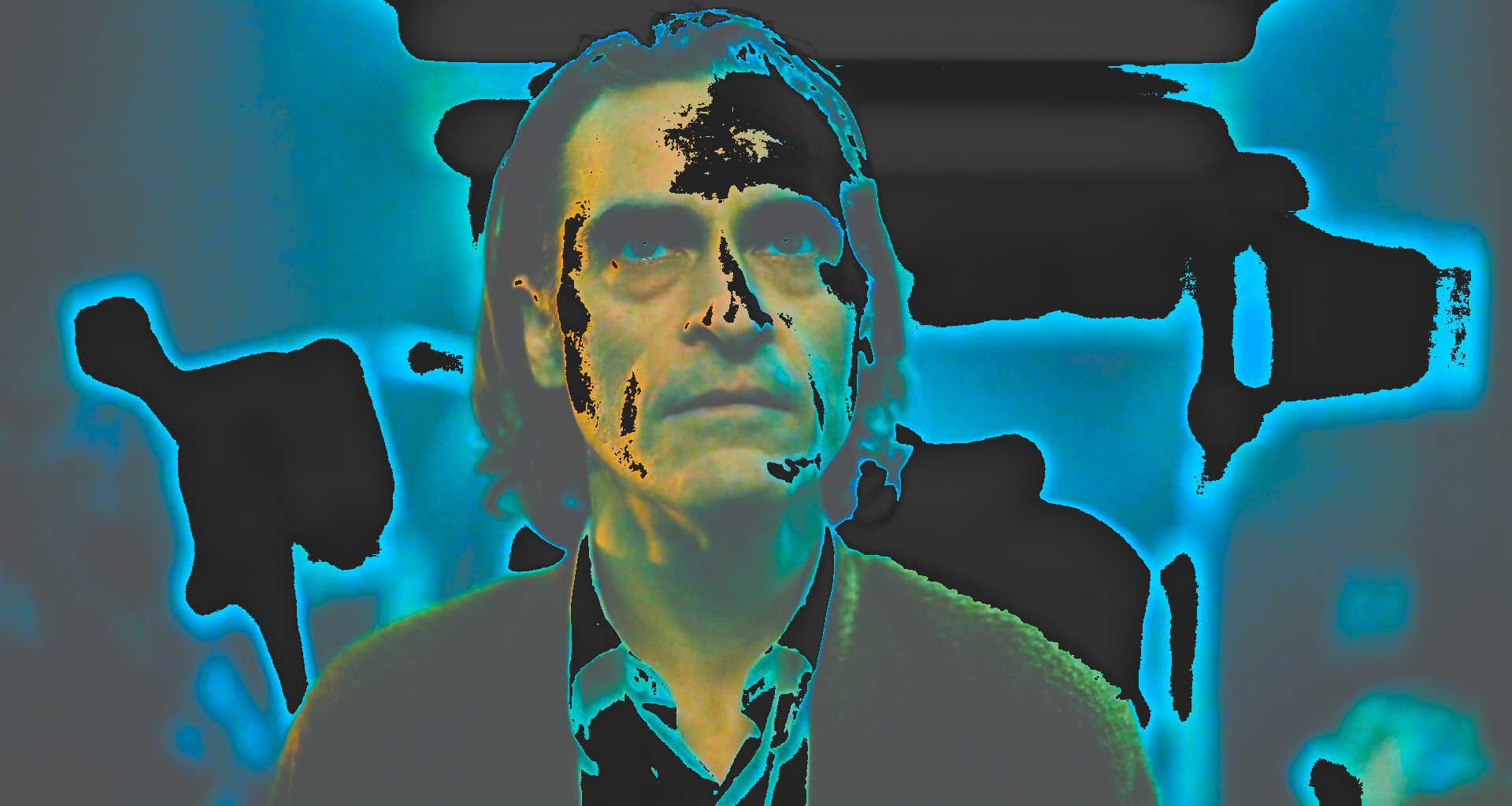 A man's face in close-up in a teal-lit room, with the dark areas lifted and intensified to cyan.