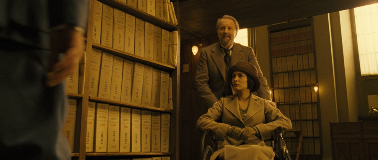 People among archive shelves in subdued amber-brown light.