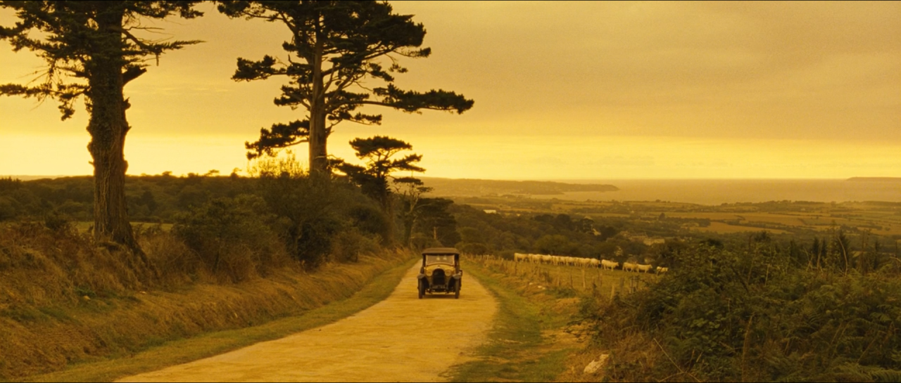 A distant road and landscape glowing in amber-yellow light.