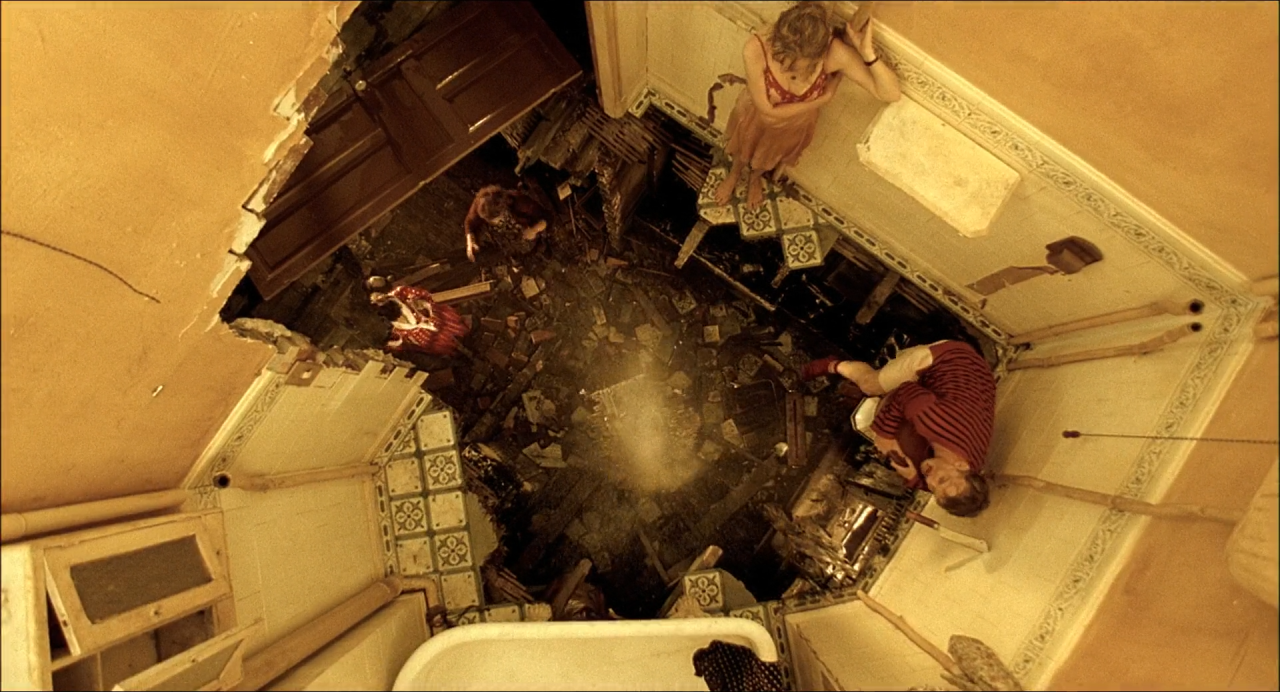 Overhead view of a busy kitchen-like room flooded with warm golden light.